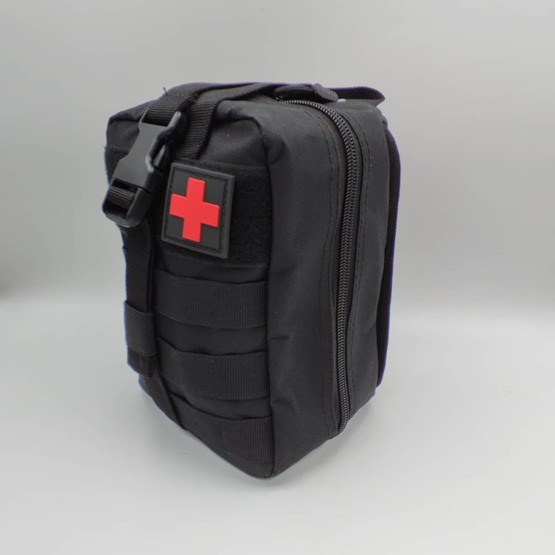 Black zippered first aid utility pouch with storage compartments and red cross patch on a white background.